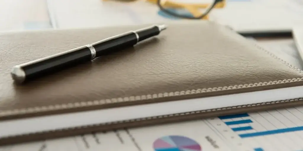 Notebook and financial report prepared for bookkeeping review