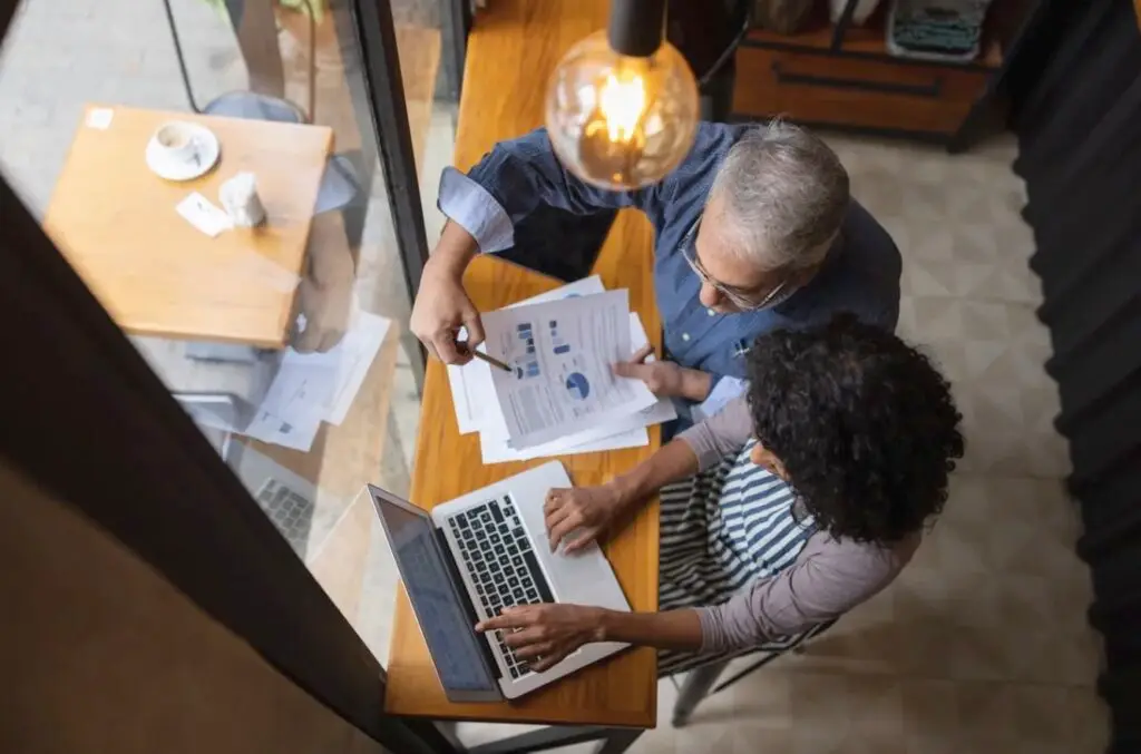 Man and a woman reviewing bookkeeping reports Man and a woman reviewing bookkeeping reports
